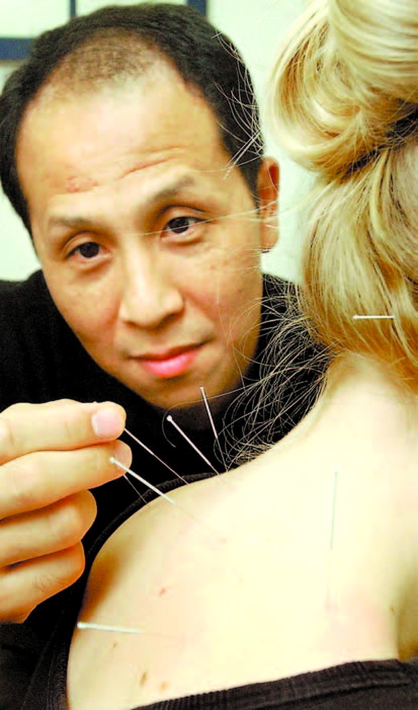 Sherman Lai demonstrating acupuncture, Guelph Mercury, October 2003